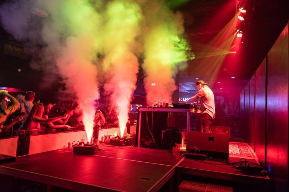 Dan Bartake aka Flatland Funk performing live on stage with Pioneer DJ equipment. The Saskatchewan-based DJ and producer, a former student of DJ Academy Vancouver, showcases his high-energy mixing skills in front of an engaged crowd."