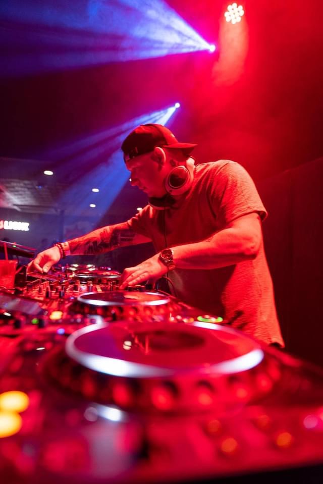 "Close-up of Dan Bartake aka Flatland Funk working on Pioneer CDJ-3000s at DJ Academy Vancouver. The experienced DJ and producer fine-tunes his mix, highlighting the hands-on training provided by the academy."